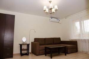 a living room with a couch and a table at Апартаменты посуточно in Sevastopol