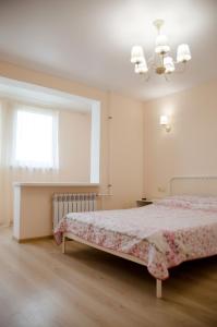 a white bedroom with a bed and a window at Апартаменты посуточно in Sevastopol