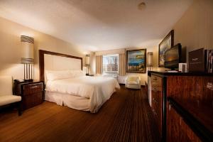 a hotel room with a bed and a window at Western Village Inn And Casino in Reno