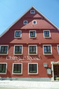 um edifício vermelho com as palavras "reutilização de chimeroser" escritas nele em Hotel Ehinger Rose em Ehingen