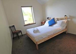 a bedroom with a bed with two slippers on it at Stones-Throw in Margaret River Town