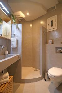 a bathroom with a shower with a toilet and a sink at The 4 Travellers Thessaloniki in Thessaloniki +54 photos