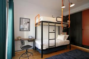 a bedroom with two bunk beds and a desk at The 4 Travellers Thessaloniki in Thessaloniki