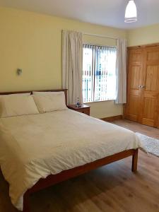 a bedroom with a large bed and a window at Clogher Valley Golf Club in Fivemiletown