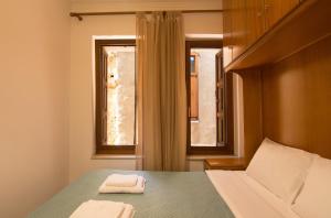 a bedroom with a bed with two towels on it at Daliani Cozy Studios in Chania