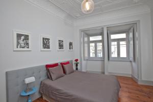 a bedroom with a bed in a white room at Apartments of the Marques in Lisbon