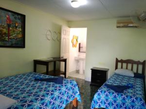 Ένα ή περισσότερα κρεβάτια σε δωμάτιο στο Hotel Margarita Sierpe