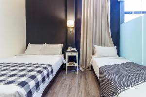 Postel nebo postele na pokoji v ubytování Ceria Hotel