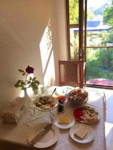 einen Tisch mit Teller mit Lebensmitteln darüber in der Unterkunft Hotel MIRA in Goris