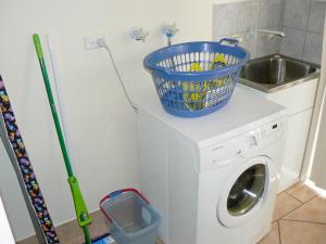 a washing machine with a basket on top of it at Geraldton Luxury Retreat 2 with free Streaming in Geraldton