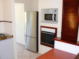 a kitchen with a stainless steel refrigerator and a microwave at Geraldton Luxury Retreat 2 with free Streaming in Geraldton