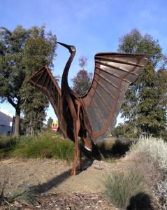 a metal statue of a bird sitting on the ground at Motel Meneres in Corowa