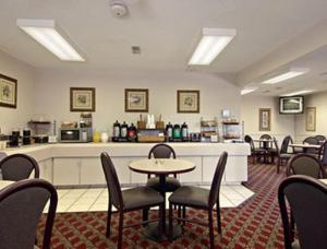 a waiting room with tables and chairs and a counter at Days Inn by Wyndham Wytheville in Wytheville