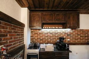 a kitchen with a brick wall and a counter at Yancheva Guest House in Delchevo