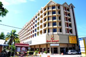 a large building on the corner of a street at Hotel Grand Continental Langkawi in Kuah