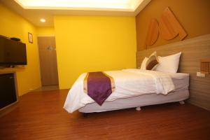 Postel nebo postele na pokoji v ubytování Kenting Waterfront Hotel