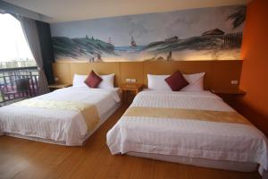 Postel nebo postele na pokoji v ubytování Kenting Waterfront Hotel