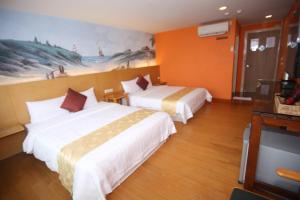 Postel nebo postele na pokoji v ubytování Kenting Waterfront Hotel