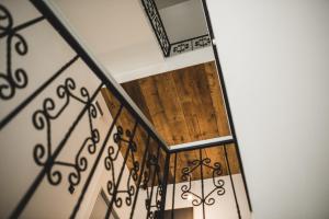 a staircase with wood and metal railing at Hotel city.city in Ostrava