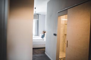 a small room with a bed and a bathroom at Hotel city.city in Ostrava