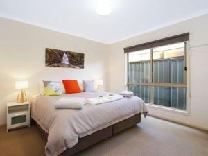 a bedroom with a large bed and a window at Bright Delight - Modern Luxury in Bright