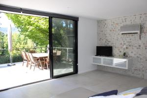 a living room with a sliding glass door and a table at Panorama Views - Bright in Bright