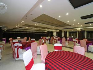 a banquet hall with pink and purple tables and chairs at Hotel Samovar in Agra