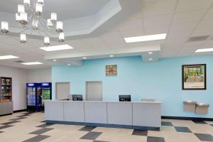 a lobby with a blue wall and a reception desk at Howard Johnson by Wyndham Florence in Florence