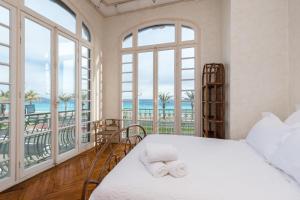 a bedroom with a bed with a view of the ocean at Villa COLLIN - Promenade des Anglais in Nice