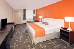 a hotel room with a bed and a flat screen tv at Howard Johnson by Wyndham Florence in Florence