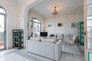a living room with a couch and a tv at Villa COLLIN - Promenade des Anglais in Nice