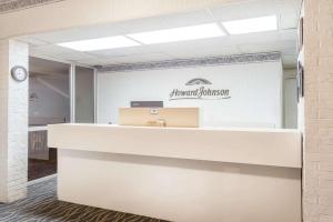 an office with a desk and a sign on the wall at Howard Johnson by Wyndham Commerce GA in Commerce