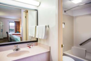 a bathroom with a sink and a mirror and a tub at Howard Johnson by Wyndham Panama City in Panama City +22 photos