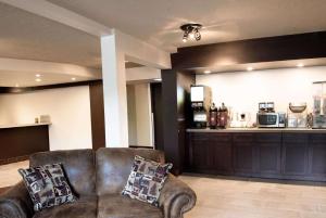 a living room with two chairs and a kitchen at Super 8 by Wyndham Juneau in Juneau