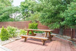 a wooden picnic table sitting on a brick patio at Super 8 by Wyndham Twinsburg/Cleveland Area in Twinsburg +8 photos