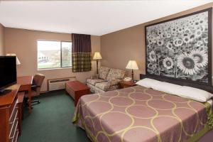 a hotel room with a bed and a desk and a chair at Circle S Motel in Anamosa +28 photos
