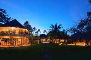 a large house with a yard at night at Avillion Villa Cinta @Sanur, Bali in Sanur