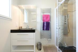 a bathroom with a sink and a shower at Logis de l'Hermitage in Le Louroux-Béconnais