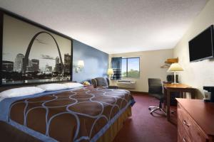 a hotel room with a bed and a desk at Super 8 by Wyndham Cuba in Cuba