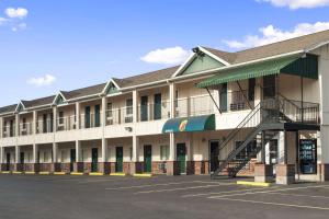 a large building with a staircase in a parking lot at Super 8 by Wyndham Mifflinville Near Bloomsburg in Mifflinville