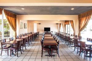 a dining room with wooden tables and chairs at Travelodge by Wyndham Monterey Bay in Monterey