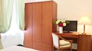 Postel nebo postele na pokoji v ubytování Hotel Villa Augustus