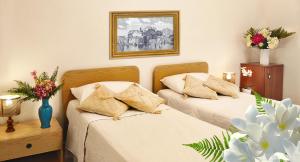 Postel nebo postele na pokoji v ubytování Hotel Villa Augustus