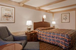 A bed or beds in a room at Knights Inn Greensburg