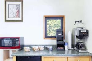 a kitchen with a counter with a coffee maker and a microwave at Knights Inn Point South Yemassee in Yemassee