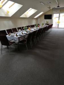 a conference room with a long table and chairs at Centrum Ostra Brama im. Jana Pawła II in Skarżysko-Kamienna