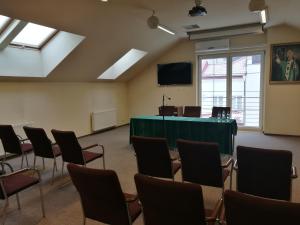 a room with chairs and a table and a podium at Centrum Ostra Brama im. Jana Pawła II in Skarżysko-Kamienna