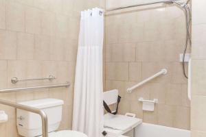 a bathroom with a toilet and a shower at Travelodge by Wyndham Sylmar CA in Sylmar