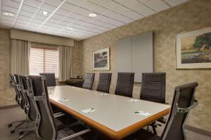 a conference room with a large table and chairs at Wingate by Wyndham Pueblo in Pueblo