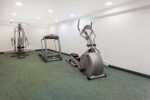 a gym with two exercise bikes and a treadmill at Super 8 by Wyndham Pincher Creek AB in Pincher Creek